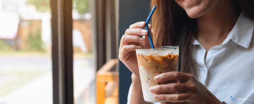 CD-A beautiful young asian woman holding and drinking iced coffee