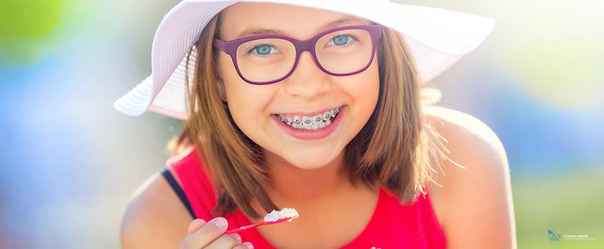 CD-Cheerful teenage girl with dental braces glasses and ice cream