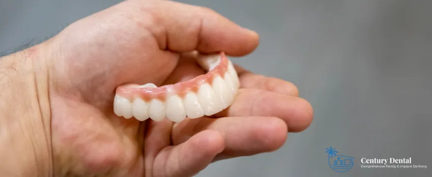 CD - Person holding dentures